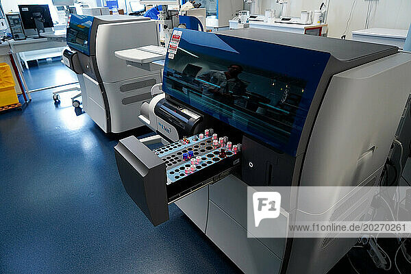 Technical platform of the Inovie 34 laboratory . A technician handling the Sta R Max 3 Analyzer to analyze blood coagulation and hemostasis.