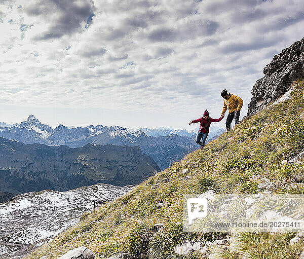 Couple moving down on mountain at Bavarian Alps in Germany