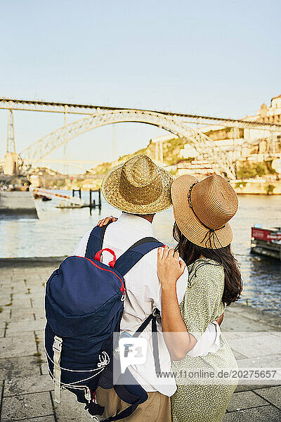 Young couple standing in front of Dom Luis bridge at Porto  Portugal