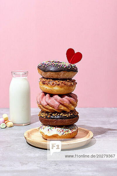 A stack of donuts with a heart on top