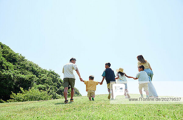 Back view of family walking together in the park