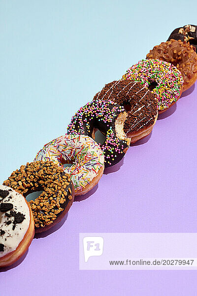 A row of donuts with sprinkles on them