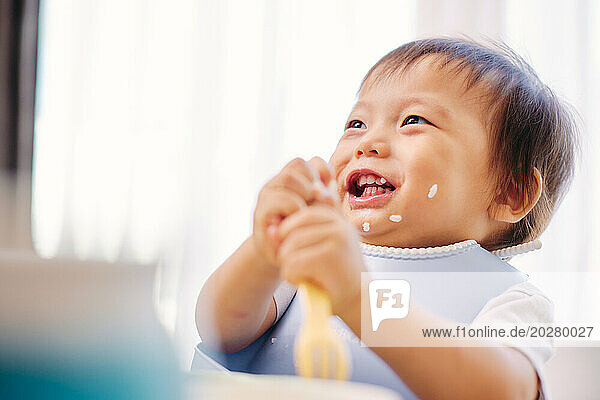 A baby eating a spoonful of food