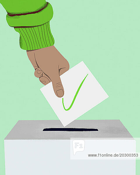 Close up hand of voter placing ballot with green check mark in ballot box