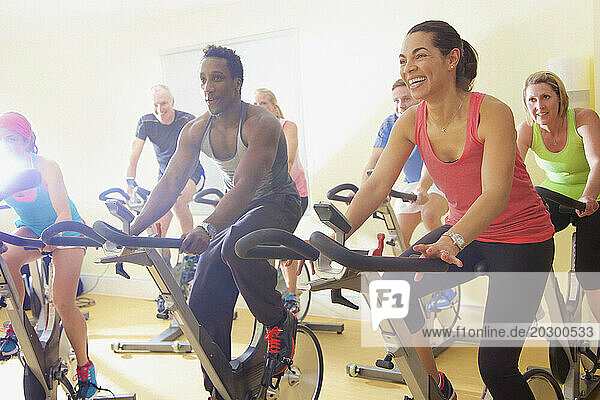 Group of People Using Exercise Bicycles at Fitness Class