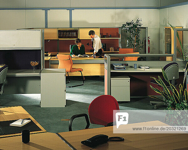 People working in office interior.