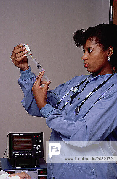 Medical professional. Female doctor with syringe.