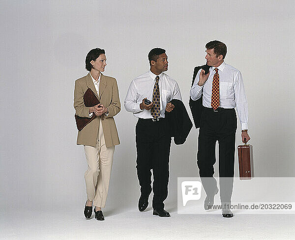 Full length view of three business executives walking.