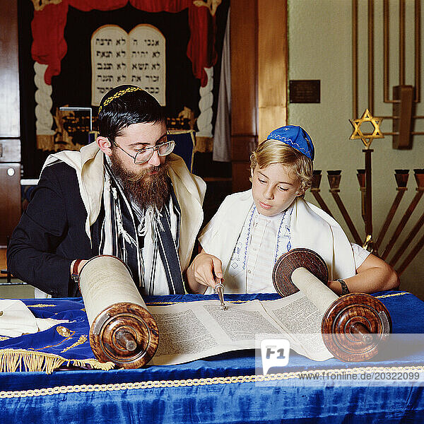 Religious instruction. Jewish Bar Mitzvah. Rabbi with young boy.