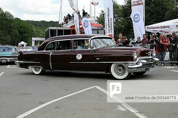 Burgundy red Cadillac classic car drives past a crowd at an event  SOLITUDE REVIVAL 2011  Stuttgart  Baden-Württemberg  Germany  Europe