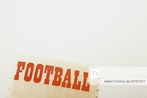 Close-up of the word Football printed in bold red letters on commemorative postage stamp on white background  Studio Composition  Quebec  Canada  North America