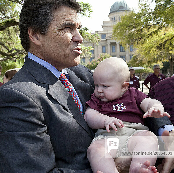 Texas Governor and 2012 Republican Presidential Candidate  Rick Perry  poses for a photo op with a baby.