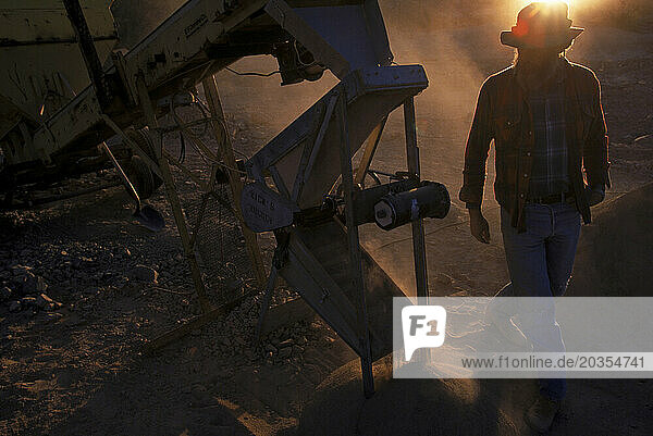 Prospector examines mining equipment  AZ  USA.