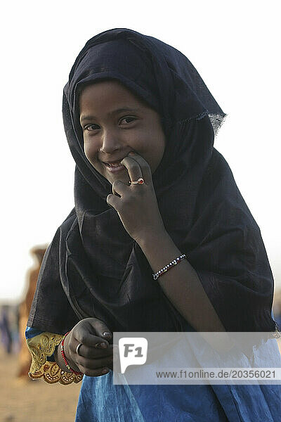 A shy Toureg girl smiles sheepishly at the camera  Gao  Mali  West Africa