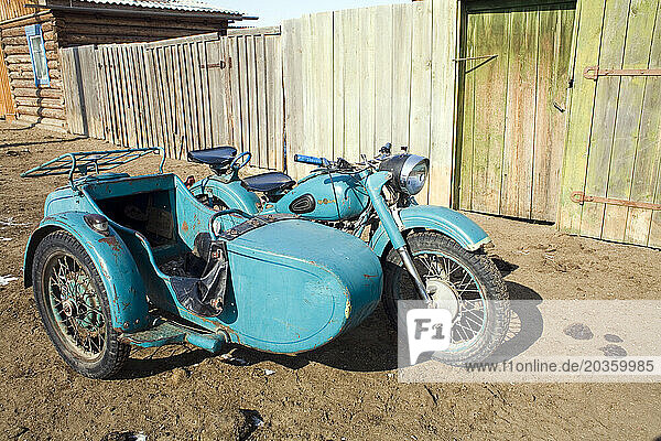 A motorbike and sidecar parked in a village on Olkhon Island  Siberia  Russia.