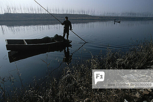 Fisherman on a boat  Boxing County  Shandong Province  China.