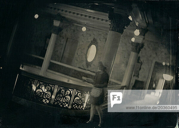 A ghostly tintype of a maid carrying a tray along a corridor of an old hotel.