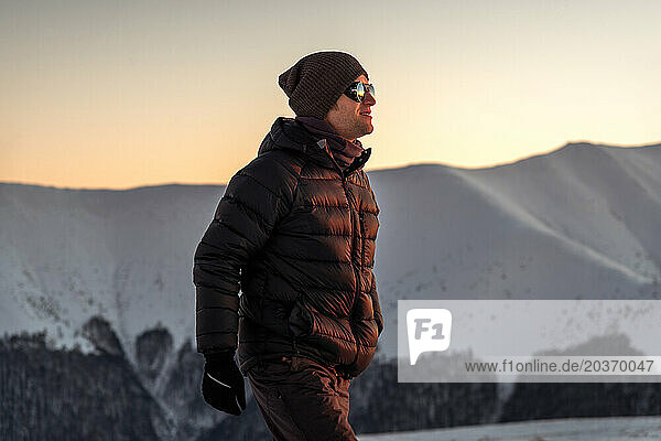 Young Man Trail Hiking In The Winter Mountains At Sunset