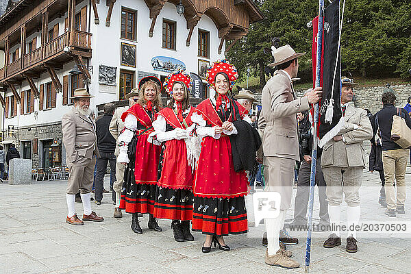 A group of Italian mountain guides are dressed in traditional clothing of the Guide Alpine Courmayeur for a parade through the village of Courmayeur.