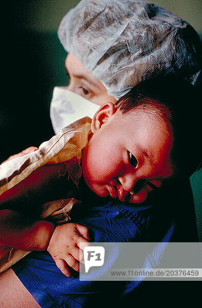 Nurse holding Chinese baby.