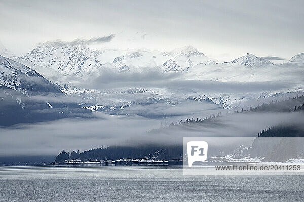 A very moody scene as the fog slowy lifts from the mountains in Haines, Alaska.