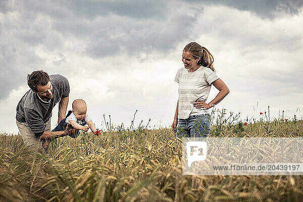 Happy family enjoying in meadow