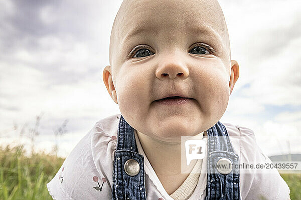Cute face of baby girl in meadow