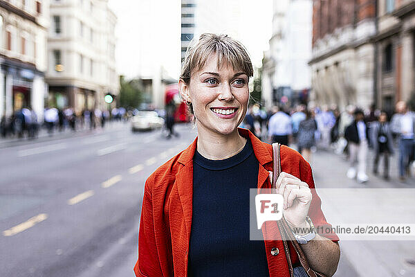 Cheerful woman standing at street