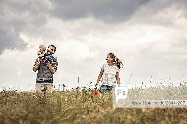 Playful family enjoying vacation at meadow
