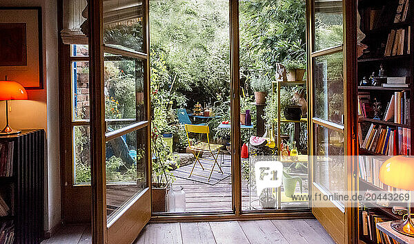 Open doors leading towards back yard garden