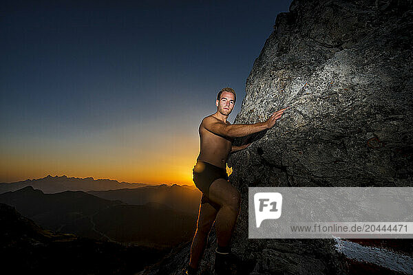 Young hiker climbing Steinfeldspitze rock at Altenmarkt  Zauchensee  Salzburg  Austria