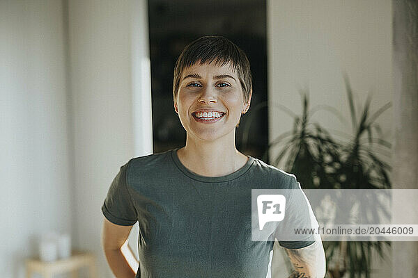 Portrait of happy woman with short hair at home