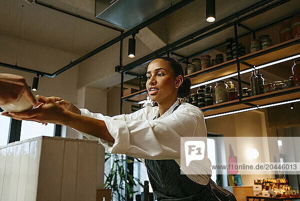 Low angle view of female chef working in commercial kitchen
