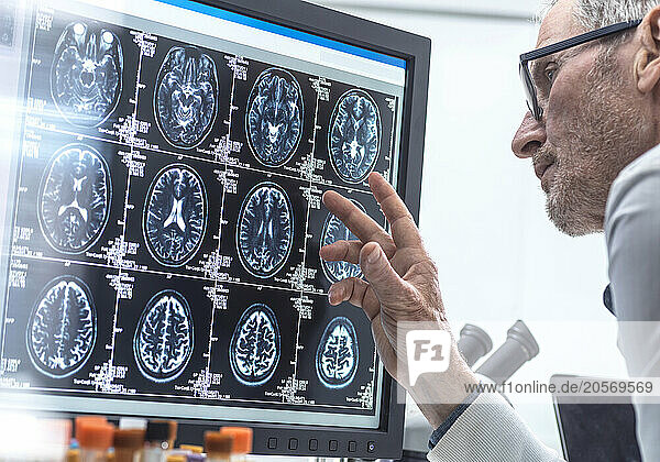 Scientist examining MRI report in laboratory
