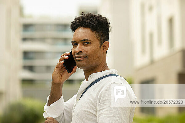 Curly hair man talking on smart phone