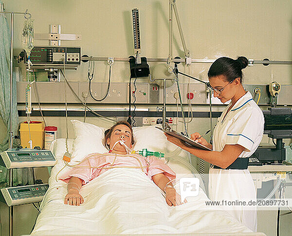 Medical hospital. Intensive care unit nurse & young female patient.