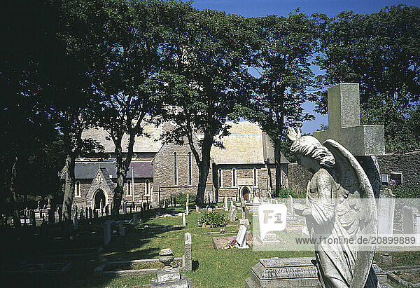 Channel Islands. Alderney. St Anne. View through trees of St Anne s Church and graveyard.