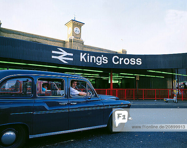 England. London. Taxi driver at Kings Cross station.