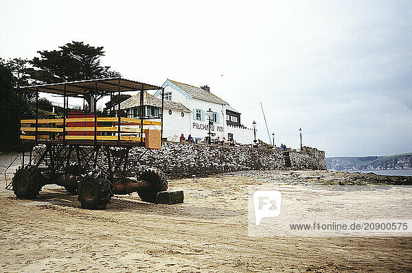 United Kingdom. England. Devon. Bigbury-on-Sea. The Pilchard Inn and deep-water tractor passenger trailer.
