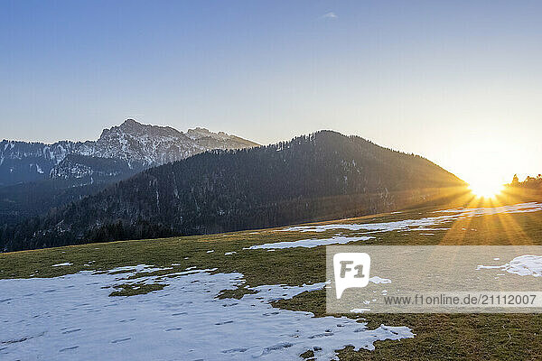 Kampenwand mountain in Bavaria at sunrise under clear sky