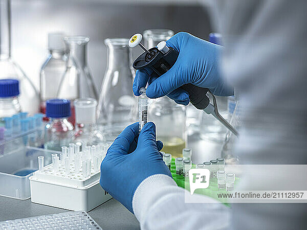 Hand of biologist closing test tube lid during DNA analysis in laboratory