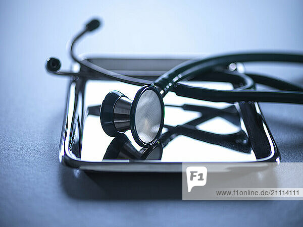 Stethoscope on a metal tray for health check and medical tests.
