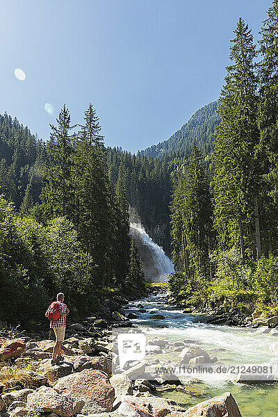 Hiker looking at Krimml Waterfalls in Hohe Tauern National Park  Austria.