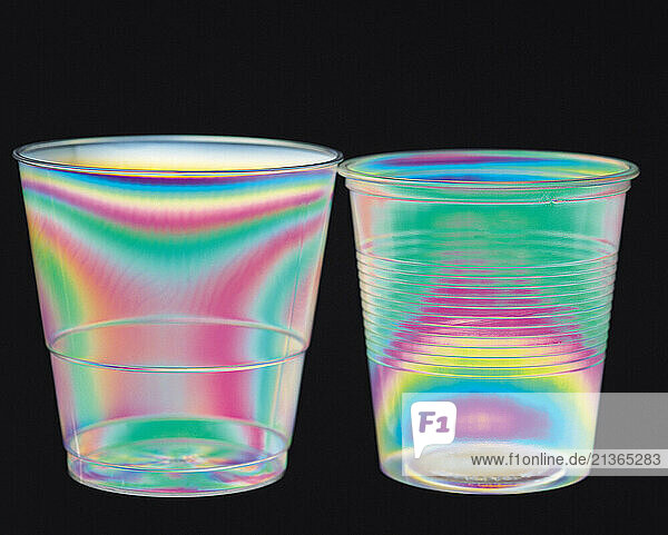 Science. Physics. Stress patterns in plastic cups photographed in polarized light.