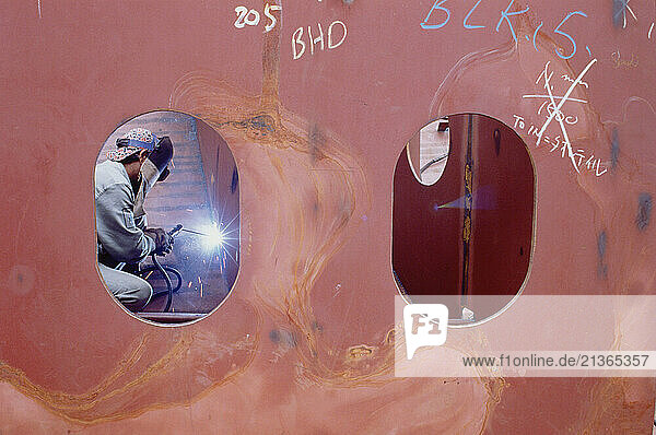 Singapore. Industry. Shipbuilding. Welder at work.