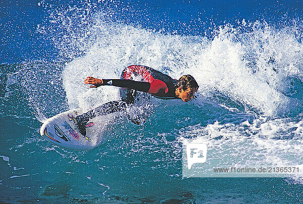 Australia. Sydney. Young man surfing a breaking wave.