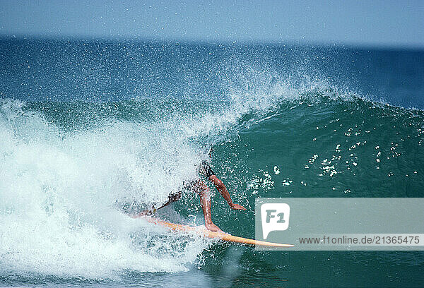 Surfing. Man surfing barrel wave.