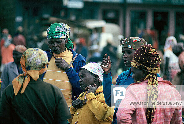 Kenya. Women & crowds outdoors in the street.