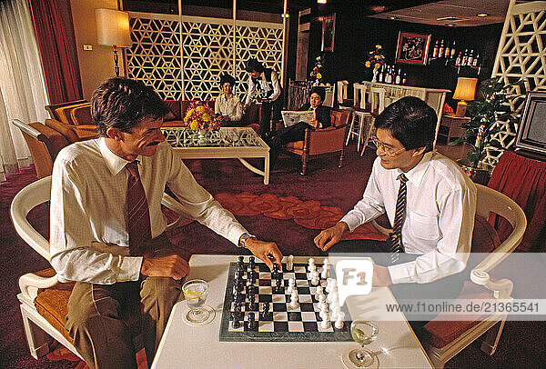 Singapore. Hotel Lounge. Two men playing game of chess.