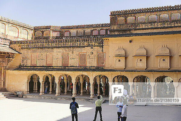 Tourists enjoy Amber Fort on a sunny day with clear blue sky; Jaipur  Rajasthan  India
